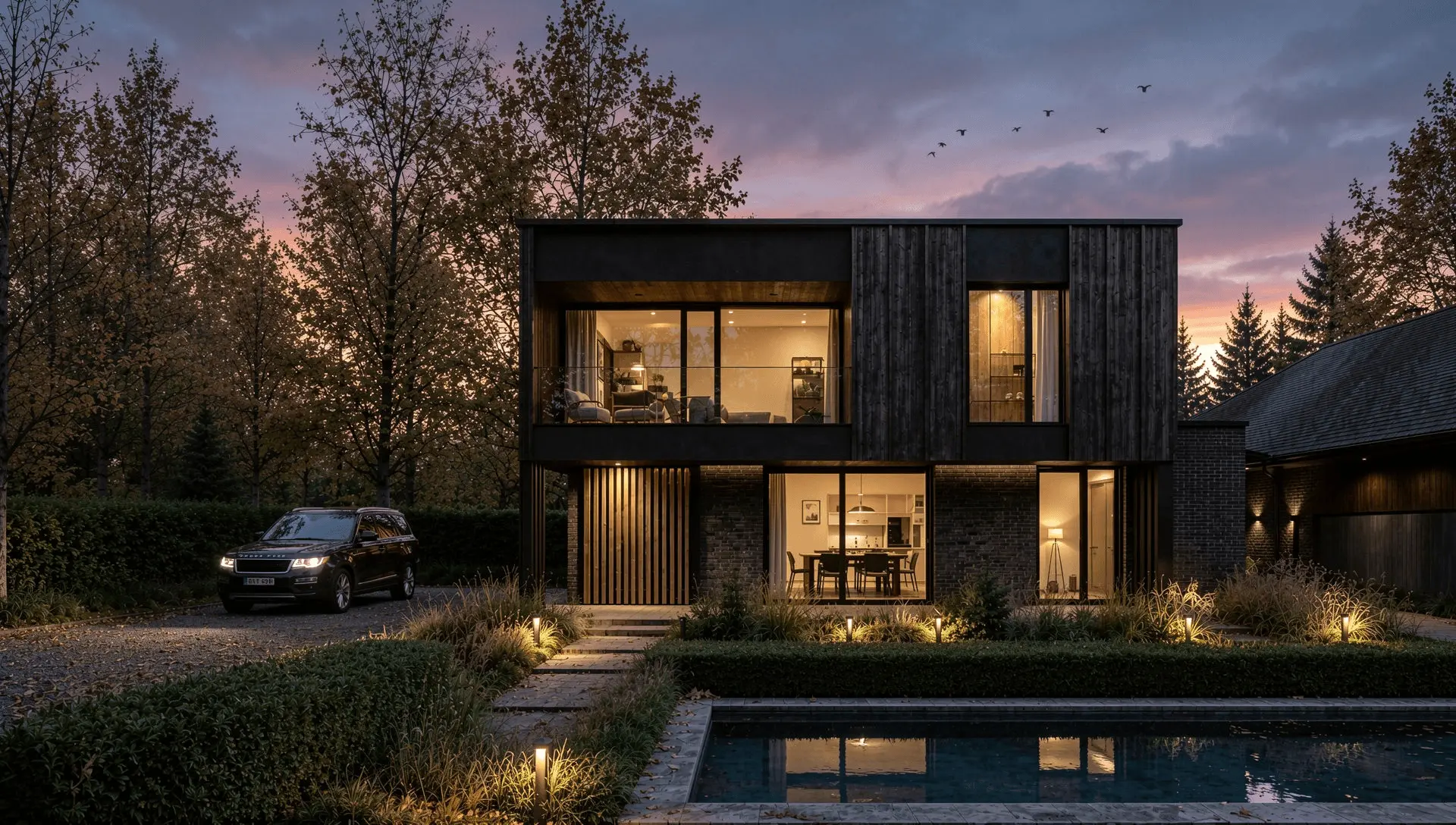 CGI render of the black timber-clad dwelling on Worsley Road, Gurnard, at dusk with the pool terrace lit CGI render of the black timber-clad dwelling on Worsley Road, Gurnard, at dusk with the pool terrace lit
